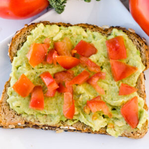 Avocado toast with tomatoes on it.