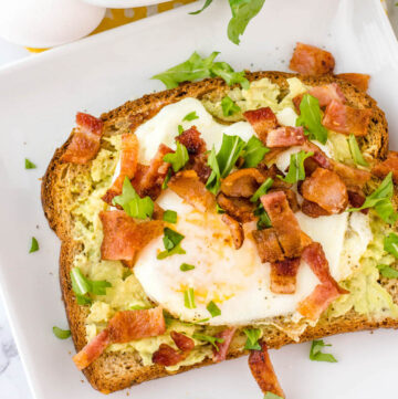 avocado toast with egg and bacon and parsely